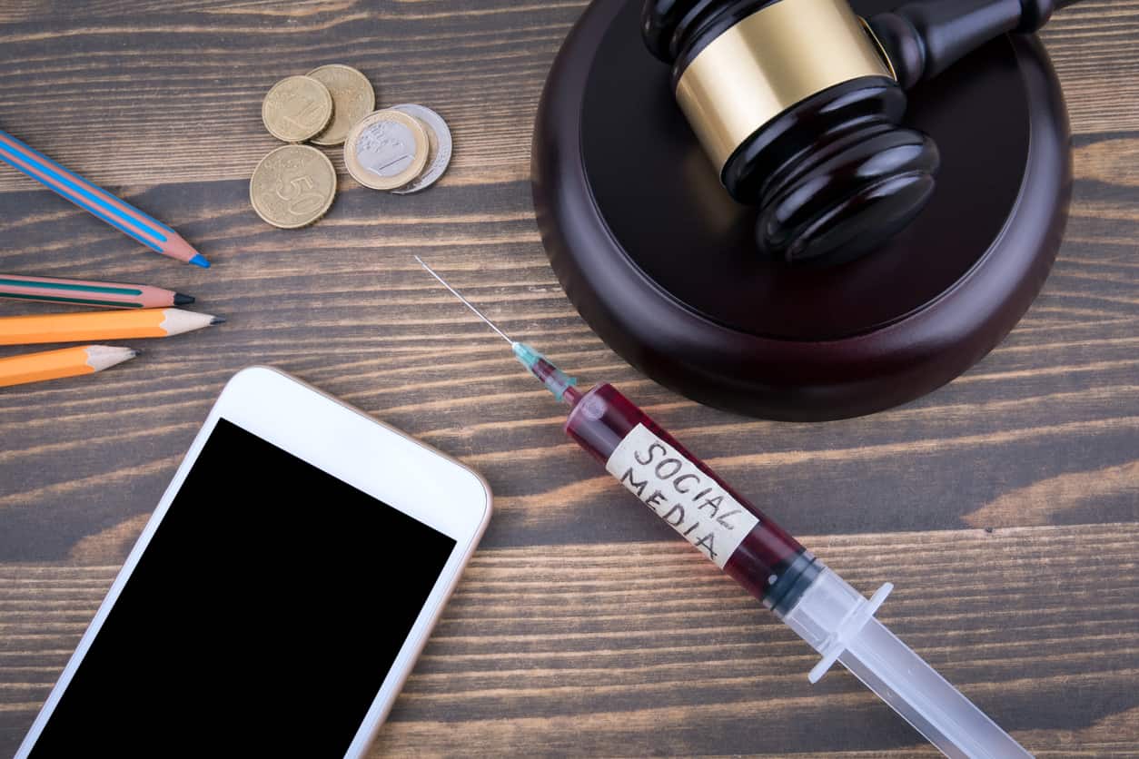 Social media impact on personal injury lawsuit with phone and legal gavel
